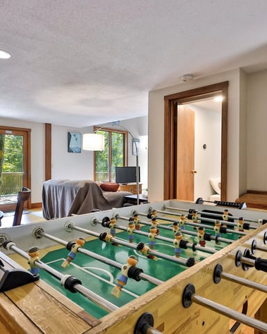 Game room with foosball table and deck access