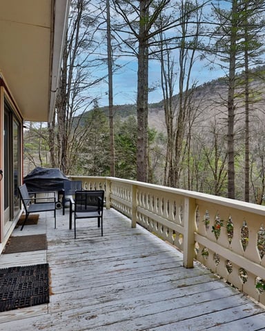 Fire pit in a summer Vermont landscape with green hills in the background.